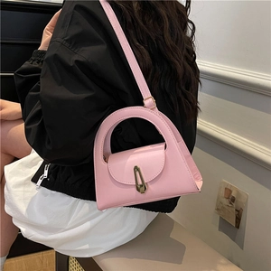 Minimalist pink semi-circular handbag with golden metal lock and round top handle