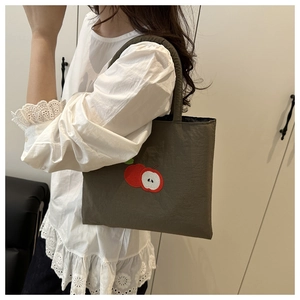 Detailed embroidery of apples on dark green nylon tote bag for women's daily use