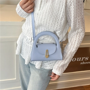 Elegant light blue trapezoid handbag with gold geometric buckle and detachable strap