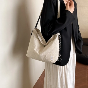 Off-white large capacity nylon crossbody bag with stylish braided rope shoulder strap