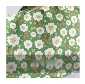 Detailed close-up of floral print fabric with daisy pattern and woven texture