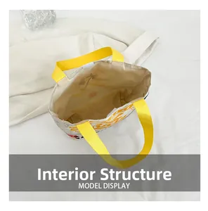 Detailed interior view of a high-capacity canvas tote bag with bright yellow handles