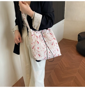 Floral drawstring bucket bag styled with a black blazer for a chic casual commute look