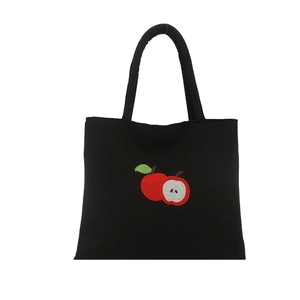 Large black canvas tote bag with detailed red apple embroidery for casual daily commuting