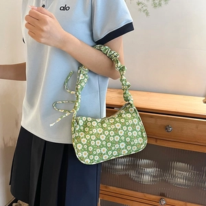 Floral print green shoulder bag with pleated handle and half-moon canvas silhouette