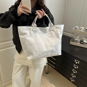 Chic white metallic large tote bag with embossed text for minimalist everyday fashion