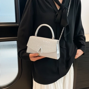 Silver glitter evening handbag with rhinestone flap and V-shaped metallic buckle detail