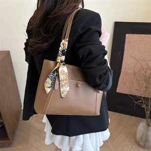 Brown leather tote bag with vintage printed scarf shown on model with chic outfit