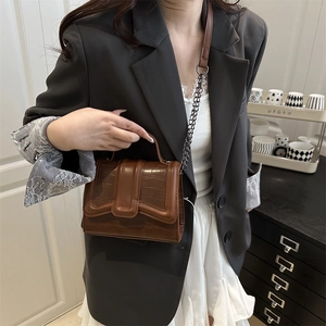 Brown crocodile embossed leather shoulder bag with chain strap and top handle style