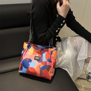 Fashionable large capacity tote bag with vibrant geometric patterns and chain strap