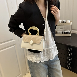 Elegant beige crossbody bag with woven texture lid and golden metal circular handle