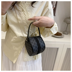 Detailed view of mini cylinder bag with grey M monogram print and gold chain strap