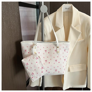 Dettaglio della borsa tote bianca floreale con pochette abbinata e rivetti in metallo