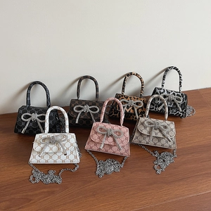 Mini bow handbags in seven colors with monogram prints and rhinestone butterfly buckles