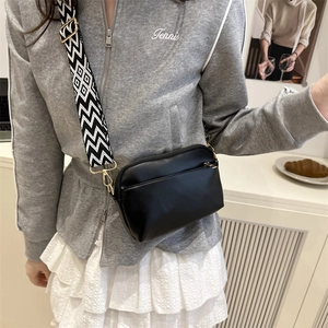 Minimalist black faux leather crossbody bag with geometric weave wide shoulder strap