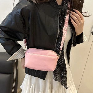 Pink minimalist PU leather square crossbody bag with geometric wide strap shown on model