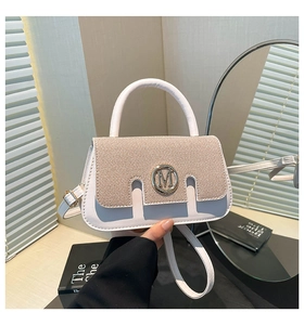 Detail of white leather and beige woven handbag with gold M buckle and round top handle