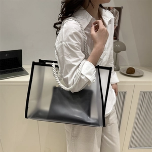 Minimalist clear PVC tote bag with white rope handles and a black inner pouch for summer