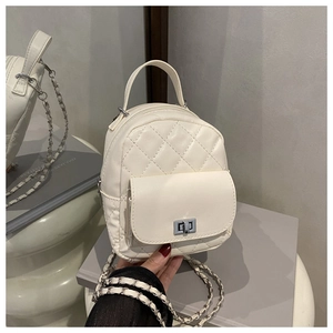 Detail of cream-white quilted mini backpack with silver twist lock and chain strap