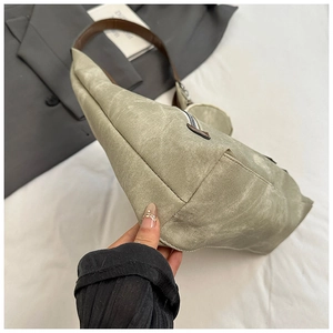 Detailed view of large hobo bag featuring vintage canvas and brown leather straps