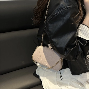 Elegant apricot chain shoulder bag with polka dot texture and rhinestone clasp detail
