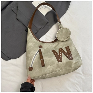 Close-up of grass green tote bag with retro matte texture and brown leather W rivet detail