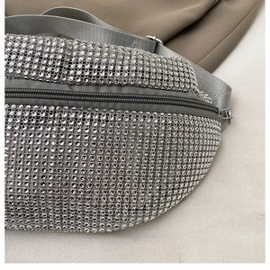 Macro view of silver rhinestone mesh and adjustable nylon strap on a casual crossbody bag