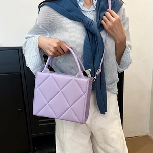 Chic lavender quilted crossbody bag with top handles and faux leather diamond pattern