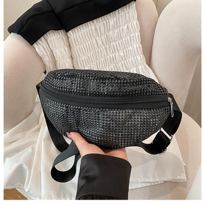 Close-up of black rhinestone fanny pack with moon shape and silver metal zipper