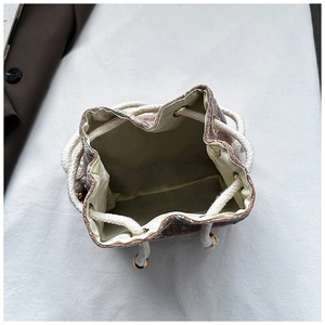 Top view of woven bucket bag showing drawstring closure and spacious inner lining
