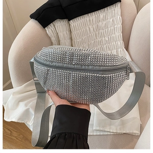Detail of silver rhinestone waist bag with wide nylon strap and sparkling crystal surface