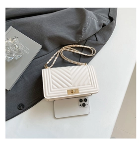 White quilted chain shoulder bag shown with a smartphone to demonstrate interior capacity