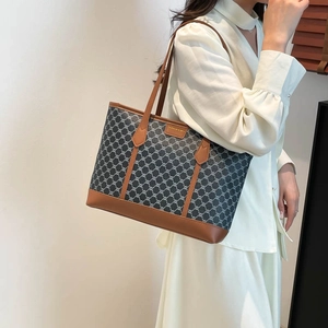 Retro grey geometric tote bag with brown trim and shoulder straps shown on a model