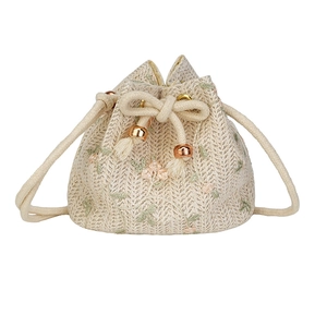 Beige woven drawstring bucket bag with floral embroidery and rose gold metal beads