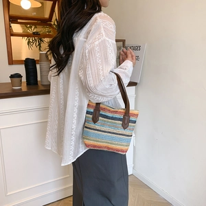 Rainbow striped woven straw beach tote bag with brown leather handles for summer vacation