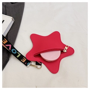 Macro detail of star-shaped leather pouch in rose red with rainbow LOVE strap