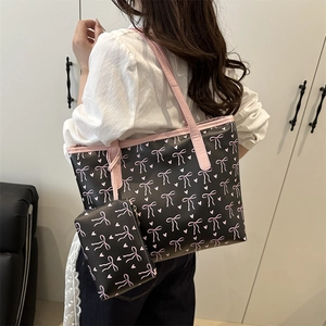 Large capacity black tote bag with pink bow prints and matching storage pouch