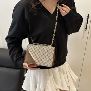 Vintage patterned crossbody bag with brown leather trim and golden metal chain strap
