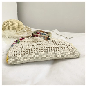 Detail of bohemian hollow knit tote bag with colorful granny square crochet patterns
