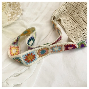 Detail of bohemian hollow crochet tote with colorful floral geometric pattern straps