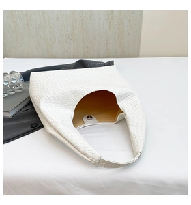 Detail of woven texture and magnetic clasp on white large capacity tote bag