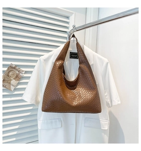 Close-up of brown woven texture and premium PU leather finish on the hobo shoulder bag