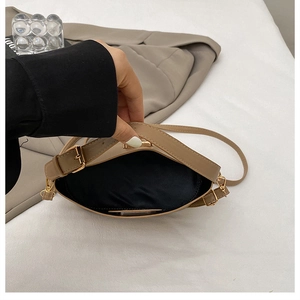 Detailed view of the khaki crossbody bag's interior space and smooth lining