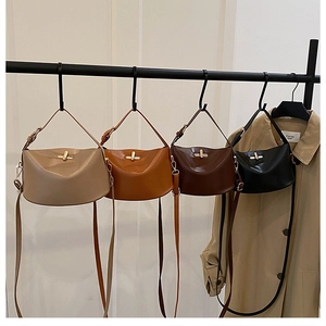 Detail of four chic half-moon crossbody bags in beige, tan, brown and black leather