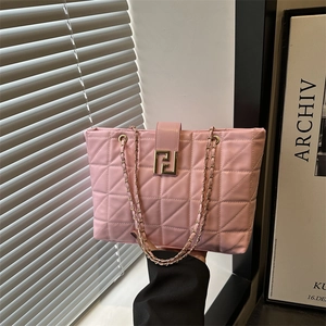 Pink quilted tote bag with geometric stitching and gold metallic buckle on chain strap