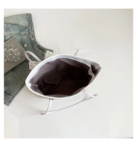 Top view of large white leather tote bag showing dark brown lining and zipper closure