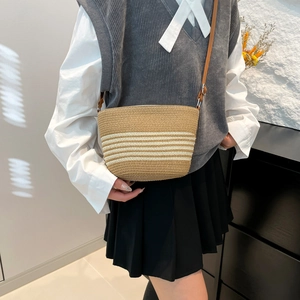 Striped woven straw crossbody bag with brown leather strap for summer beach vacation style