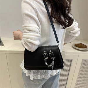 Fashionable black faux leather shoulder bag with belt buckles and silver chain detail