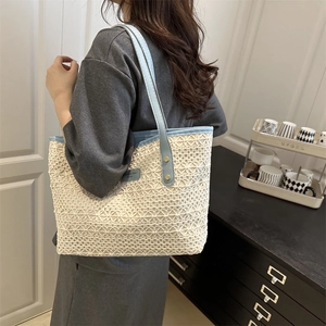 Chic crochet tote bag with light blue leather straps and ivory lace knit patterns