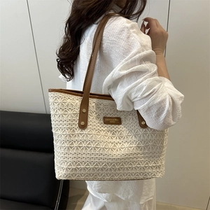 Minimalist beige crochet tote bag with brown leather handles for stylish women commuting